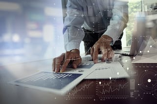 close up of businessman hand working on laptop computer with financial business graph information diagram on wooden desk as concept.jpeg